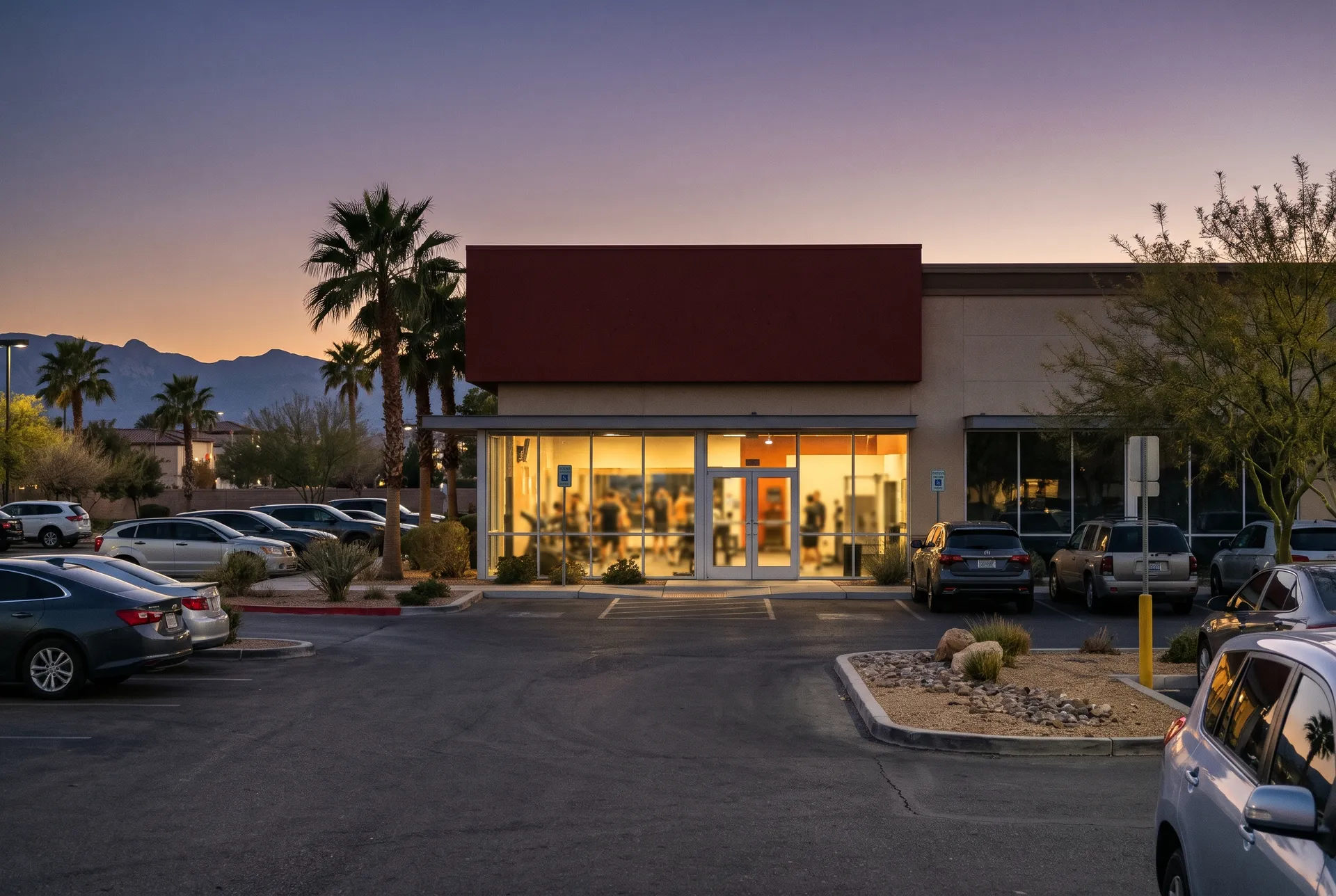 A Peregrine Fitness club in a Las Vegas shopping center at dusk with free parking out front